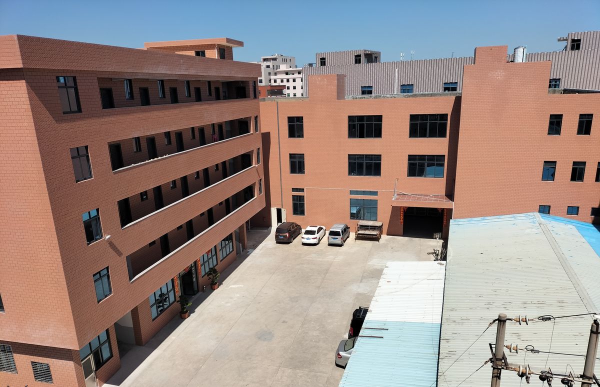 The production partner's facility, seen across its yard.